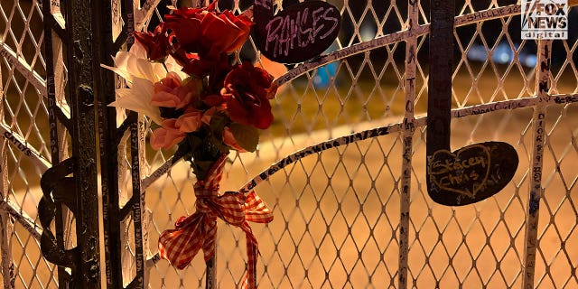 Fans pay tribute on the gates of Graceland following Lisa Marie Presley's death.