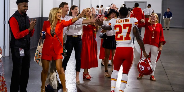 Kansas City Chiefs cornerback Rashad Fenton, #27, celebrates with Gracie Hunt and other members of the Chiefs ownership group after defeating the Arizona Cardinals at State Farm Stadium in Glendale, Arizona, Sept. 11, 2022.