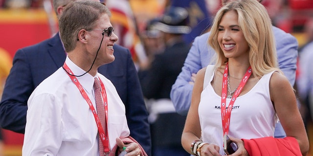 Kansas City Chiefs CEO Clark Hunt, left, talks with his daughter Gracie Hunt on the sidelines against the Washington Commanders prior to the game at GEHA Field at Arrowhead Stadium in Kansas City, Missouri, Aug. 20, 2022.