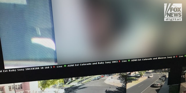 Security images visible on a computer monitor showing an area that appears to be near WSU's Greek Row. The occupants have been blurred out.