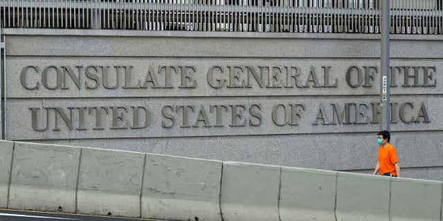 A man walks past U.S. Consulate in Hong Kong Monday, March 15, 2021.