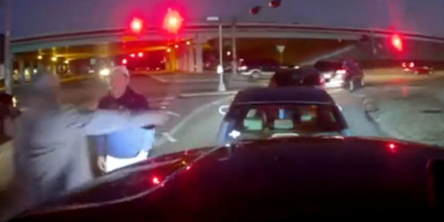 After entering the lane, both vehicles come to a halt and the suspect, who Houston Police say was driving a gray/silver Honda Accord, appears to exchange words with the victim.