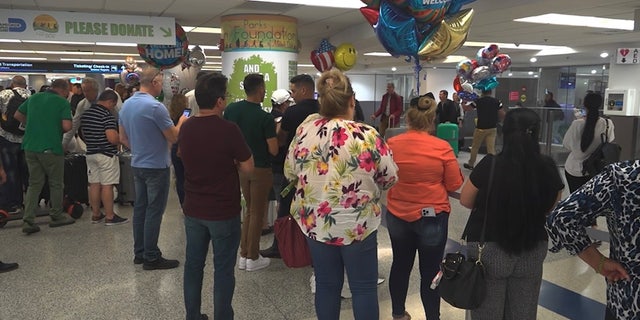 Hundreds of migrants wait to reunite with family at the Miami International Airport. 