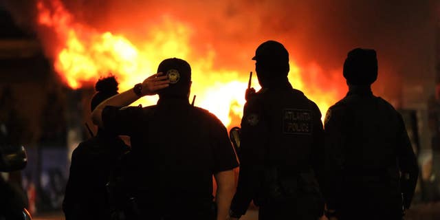 Burning cop cars in Atlanta, Georgia on Saturday, Jan. 21, 2023.