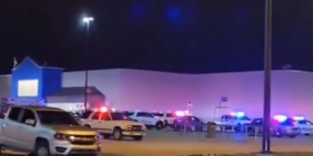 Police cars seen outside an Indiana Walmart. At least one person was shot and injured by the gunman, Evansville Police said.