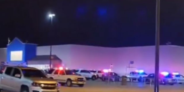 Police cars seen outside an Indiana Walmart. At least one person was shot and injured by the gunman, Evansville Police said.