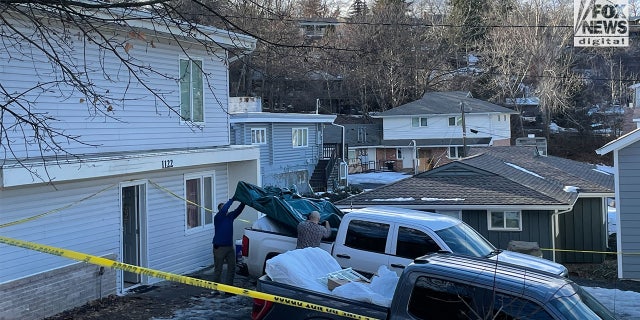 Individuals remove items including a mattress with potential blood stains from the home where four University of Idaho students were murdered.