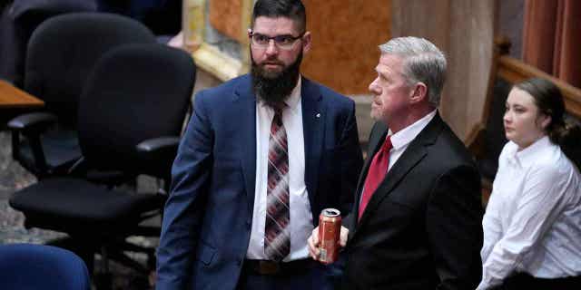 Iowa House Majority Leader Matt W. Windschitl, left, talks with State Sen. Brad Zaun, during debate on a bill that would create education savings accounts, on Jan. 23, 2023, in Des Moines, Iowa. The bill to allow students to use public funds to pay tuition for private schools passed in Iowa.