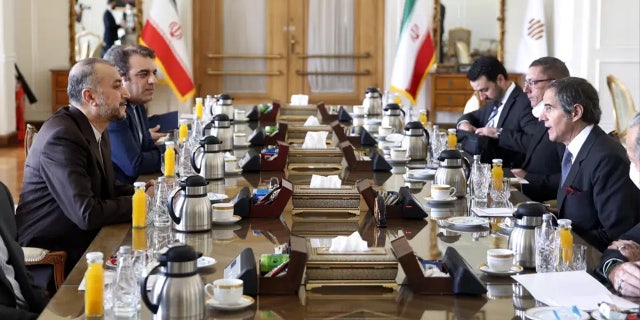 Director General of the International Atomic Energy Agency Rafael Mariano Grossi (right) talks with Iranian Foreign Minister Hossein Amirabdollahian (left) during their meeting in Tehran, Iran, March 5, 2022.