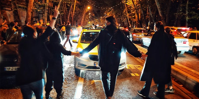 Women protest the death of 22-year-old Mahsa Amini, who was detained by the morality police, in Tehran, Oct. 1, 2022.