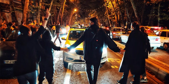 Women protest the death of 22-year-old Mahsa Amini, who was detained by the morality police, in Tehran, Oct. 1, 2022.