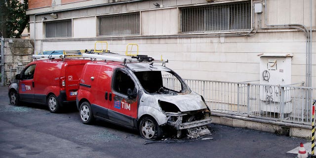 A damaged car remains parked on the streets of Rome following an attack claimed by an anarchist network on Jan. 30, 2023.