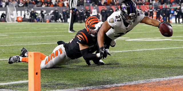 Baltimore Ravens' JK Dobbins dives into the end zone to score against the Bengals during the wild card playoff game at Paycor Stadium on January 15, 2023 in Cincinnati.