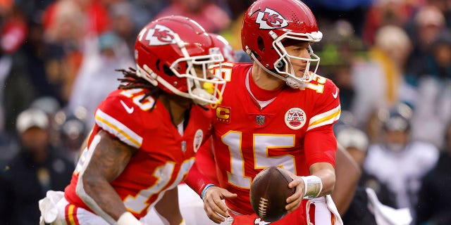 Patrick Mahomes (15) of the Kansas City Chiefs backs up against the Jacksonville Jaguars during the first quarter of an AFC divisional playoff game at Arrowhead Stadium on January 21, 2023 in Kansas City, Missouri.