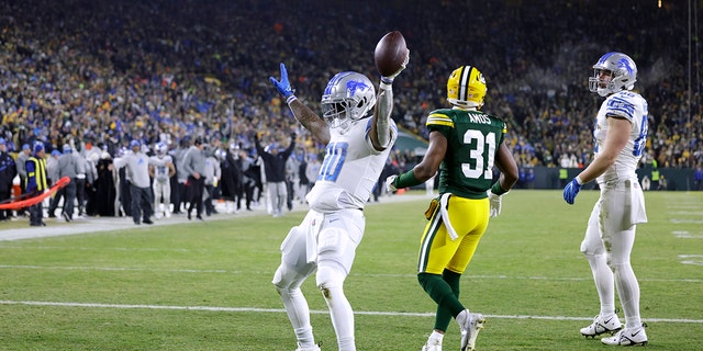 Detroit Lions running back Jamaal Williams celebrates after scoring during the second half of an NFL football game against the Green Bay Packers Sunday, Jan. 8, 2023, in Green Bay, Wis.
