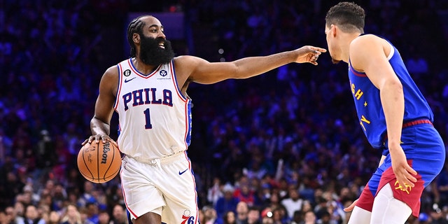 Sixers guard James Harden controls the ball against Denver Nuggets forward Michael Porter Jr. on January 28, 2023 in Philadelphia.