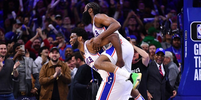 Sixers guard James Harden celebrates with center Joel Embiid after a score against the Denver Nuggets at Wells Fargo Center in Philadelphia, Jan. 28, 2023.