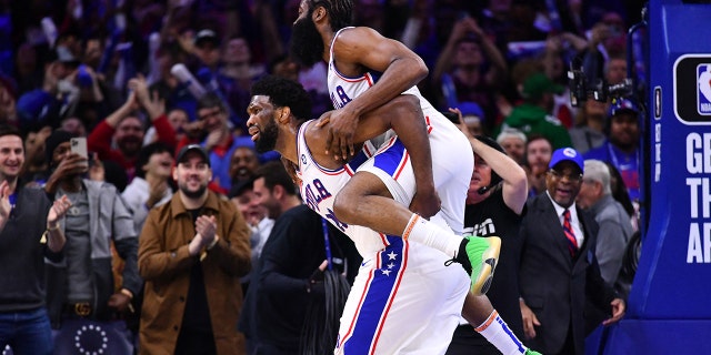 Sixers guard James Harden celebrates with center Joel Embiid after a score against the Denver Nuggets at Wells Fargo Center in Philadelphia, Jan. 28, 2023.