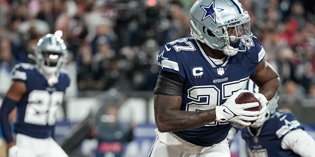 Dallas Cowboys safety Jayron Kearse (27) runs in the end zone after his interception against the Tampa Bay Buccaneers during the first half of an NFL wild card game, Monday, Jan. 16, 2023, in Tampa, FL.