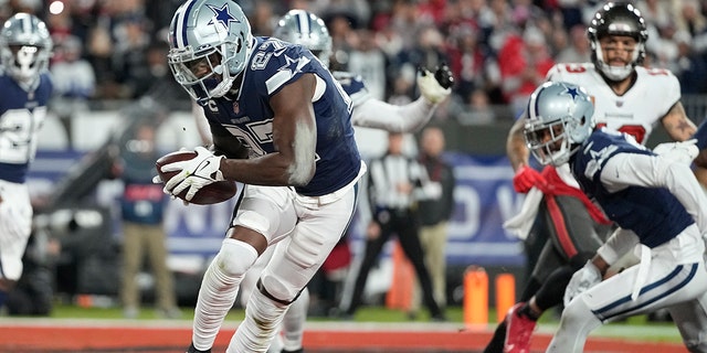 Dallas Cowboys safety Jayron Kearse (27) runs in the end zone after his interception against the Tampa Bay Buccaneers during the first half of an NFL wild-card football game, Monday, Jan. 16, 2023, in Tampa, Fla. 