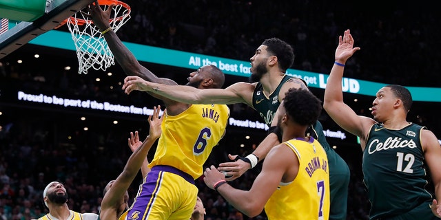 Los Angeles Lakers' LeBron James (6) misses a shot against Boston Celtics' Jayson Tatum, top center, late in the fourth quarter of an NBA basketball game Saturday, Jan. 28, 2023, in Boston.