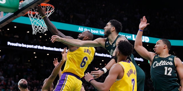 Los Angeles Lakers' LeBron James (6) misses a shot against Boston Celtics' Jayson Tatum, top center, late in the fourth quarter of a game Saturday, Jan. 28, 2023, in Boston.