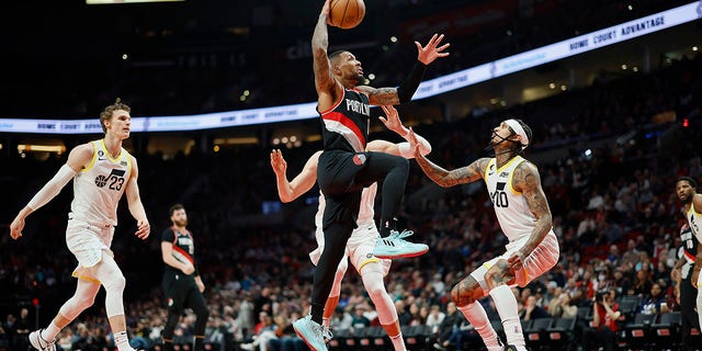 Damian Lillard #0 of the Portland Trail Blazers drives to the basket against Jordan Clarkson #00 of the Utah Jazz during the second half at Moda Center on January 25, 2023, in Portland, Oregon.