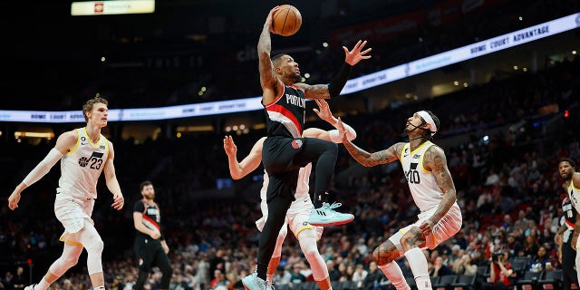 Damian Lillard #0 of the Portland Trail Blazers drives to the basket against Jordan Clarkson #00 of the Utah Jazz during the second half at Moda Center on January 25, 2023, in Portland, Oregon.