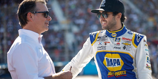 Chase Elliott, driver of the No. 9 NAPA Auto Parts Chevrolet, and Jeff Gordon, vice president of Hendrick Motorsports, speak before the NASCAR Cup Series Championship at Phoenix Raceway on November 6, 2022 in Avondale, Arizona.