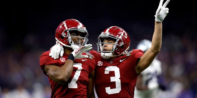 Ja'Corey Brooks, left, of the Alabama Crimson Tide reacts with Jermaine Burton after scoring a touchdown against the Kansas State Wildcats on December 31, 2022 in New Orleans.