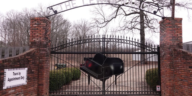 The front gate outside the Mississippi home of late entertainer Jerry Lee Lewis features a massive piano.