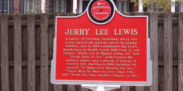 A sign outside the Mississippi home of entertainer Jerry Lee Lewis pays homage to the late musician.