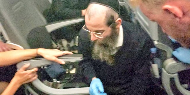 A passenger said the man wearing gloves was a trained EMT. He helped stabilize a woman who fainted mid-flight.