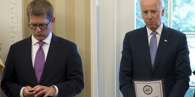 Then-Vice President Joe Biden and Jay Carney attend a meeting.