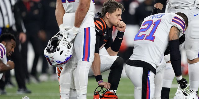 Joe Burrow #9 of the Cincinnati Bengals and Jordan Poyer #21 of the Buffalo Bills react after injury to Damar Hamlin #3 during the first quarter at Paycor Stadium on January 2, 2023 in Cincinnati, Ohio. 