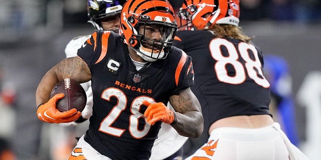 Joe Mixon #28 de los Cincinnati Bengals encabeza el balón contra los Baltimore Ravens durante el primer cuarto del partido de playoffs de la AFC Wild Card en el Paycor Stadium el 15 de enero de 2023 en Cincinnati, Ohio.