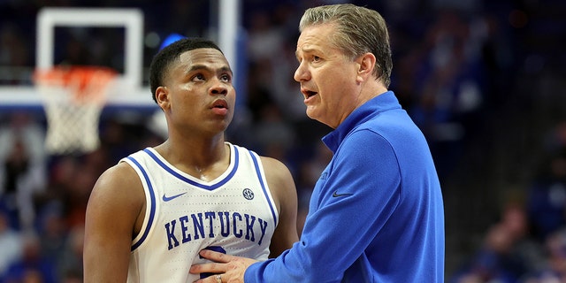 Kentucky's Sahvir Wheeler, left, receives instruction from head coach John Calipari during the second half of an NCAA college basketball game against South Carolina in Lexington, Kentucky, Tuesday, Jan. 10, 2023.