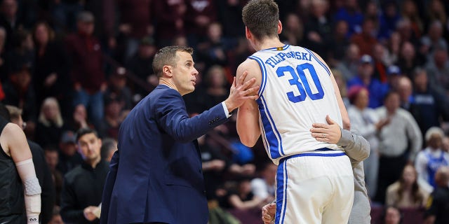 Head coach Jon Scheyer and center Kyle Filipowski (30) of the Duke Blue Devils in the second half during a game against the Virginia Tech Hokies at Cassell Coliseum Jan. 23, 2023, in Blacksburg, Va.