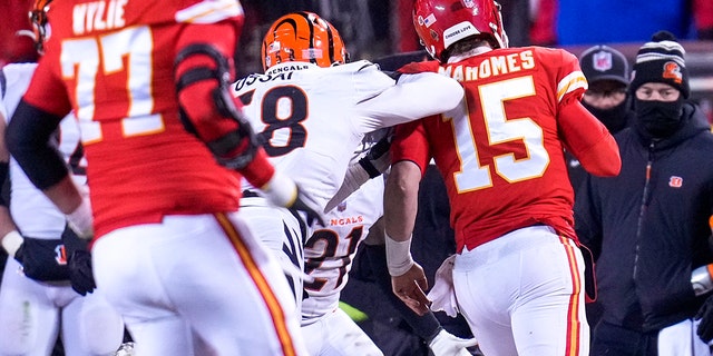 Cincinnati Bengals defensive end Joseph Ossai, #58, shoves Kansas City Chiefs quarterback Patrick Mahomes, #15, as he scrambles out of bounded, resulting in a roughing the passer penalty and putting the Chiefs in field goal position in the fourth quarter of the AFC championship NFL game between the Cincinnati Bengals and the Kansas City Chiefs, Sunday, Jan. 29, 2023, at Arrowhead Stadium in Kansas City, Missouri.