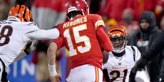 Cincinnati Bengals defensive end Joseph Ossai, left, is called for roughing the passer as Chiefs quarterback Patrick Mahomes is hit out of bounds during the AFC championship Game, Sunday, Jan. 29, 2023, at GEHA Field at Arrowhead Stadium in Kansas City, Missouri.