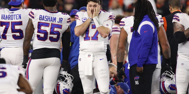 Buffalo Bills quarterback Josh Allen, #17, reacts as medical personnel attend to Buffalo Bills safety Damar Hamlin.