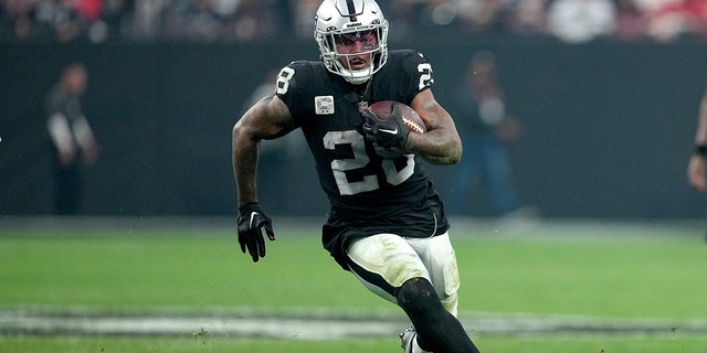 Josh Jacobs #28 of the Las Vegas Raiders carries the ball against the Kansas City Chiefs during the second half of the game at Allegiant Stadium on January 07, 2023 in Las Vegas, Nevada.