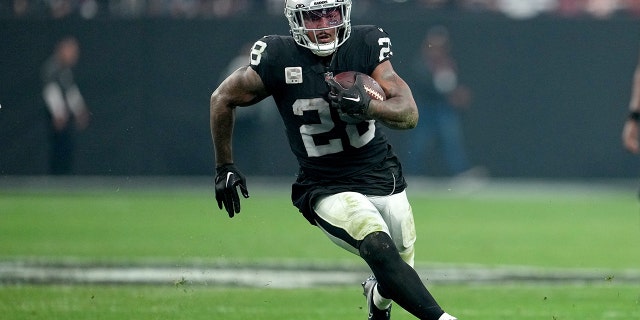 Josh Jacobs of the Raiders carries the ball against the Kansas City Chiefs on January 7, 2023 in Las Vegas.