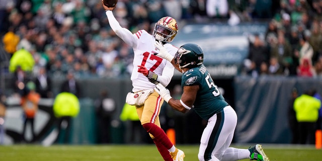 San Francisco 49ers quarterback Josh Johnson, left, passes under pressure from Philadelphia Eagles defensive end Brandon Graham during the first half of the NFC Championship NFL football game between the Philadelphia Eagles and the San Francisco 49ers on Sunday, Jan. 29, 2023, in Philadelphia.