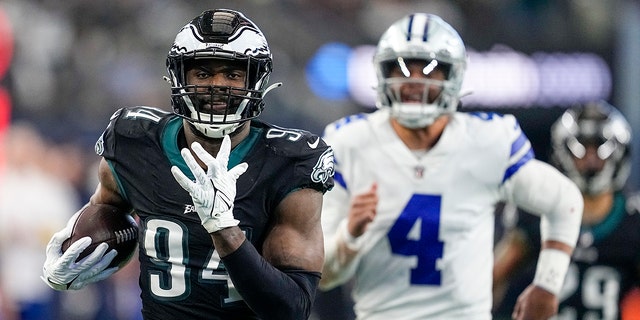 Philadelphia Eagles' Josh Sweat intercepts a pass from Dallas Cowboys quarterback Dak Prescott and returns it for a touchdown during the first half of a game on December 24, 2022 in Arlington, Texas. 
