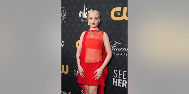 Julia Garner wears a short, sheer red ensemble to the 28th Annual Critics Choice Awards. 