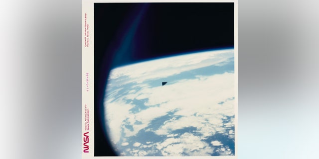 A triangular piece of orbital debris (a piece of thermal insulation tile) high above planet Earth, as seen from the Space Shuttle Columbia during mission STS-61-C, January 12-18, 1986. 