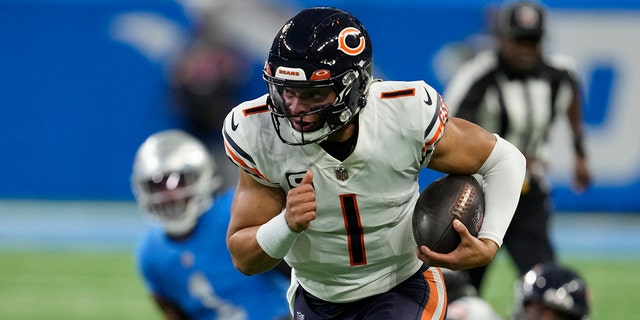 Chicago Bears quarterback Justin Fields battles during the first half of an NFL football game against the Detroit Lions, Sunday, Jan. 1, 2023, in Detroit. 