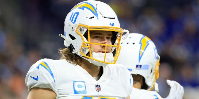 Justin Herbert, #10 of the Los Angeles Chargers, looks on in the game against the Indianapolis Colts at Lucas Oil Stadium on December 26, 2022, in Indianapolis, Indiana.