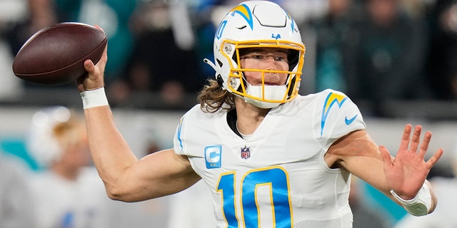 Los Angeles Chargers quarterback Justin Herbert throws a pass against the Jacksonville Jaguars during the first half of a wild-card playoff game, Saturday, Jan. 14, 2023, in Jacksonville, Florida.